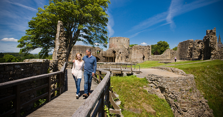 couple walking through ruins of Barnard Castle